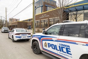 Several London Police cruisers are parked outside HB Beal Secondary School in downtown London after a schoolgirl was stabbed in the cafeteria on Monday 21 November 2022. (Mike Hensen/The London Free Press)