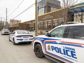 Several London police cruisers were parked outside H.B. Beal secondary school in downtown London after a female student was stabbed in the cafeteria on Monday, Nov. 21, 2022. (Mike Hensen/The London Free Press)