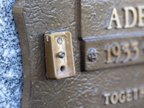 More than 40 bronze vases and plaques were stolen last week from St. Peter's Cemetery in London. A vase was stolen from this plaque, leaving only the mounting point. Photograph taken on Tuesday, Nov. 22, 2022. (Mike Hensen/The London Free)
