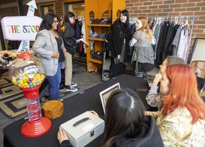 Mika Nath, a fashion design student at Fanshawe College, tries on a jacket and gets positive reviews from classmates Wednesday at a pop-up store on campus run by fashion marketing and management students Wednesday and Thursday.
The store is the product of a long collaboration between the college and Goodwill Industries and promotes sustainability and raises funds for a student scholarship at the school. (Mike Hensen/The London Free Press)