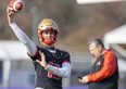 Arnaud Desjardins, starting quarterback for the Laval Rouge et Or, keeps his arm warm Thursday as head coach Glen Constantin looks on in the background.
Laval and the Saskatchewan Huskies meet in London at Alumni Field Saturday for the Vanier Cup. 
(Mike Hensen/The London Free Press)