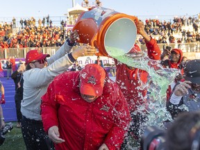 Glen Constantin, head coach of the Laval Rouge et Or, avoids most of the traditional Gatorade shower after winning the Vanier Cup, 30-24, over the University of Saskatchewan Huskies in London on Saturday November 26, 2022. Mike Hensen/The London Free Press