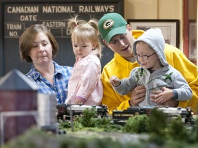 Three-year-old Owen Vanderbaan, right, watches a train roll past with dad Nic, mom Andrea and sister Gabby, 1, at the London Model Railroad Group's layout in 2011. On Tuesday, the club is holding its first open house at its newest location on Blakie Road. (Free Press file photo)