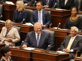 Ontario Premier Doug Ford reacts after Lt.-Gov. Elizabeth Dowdeswell delivered her Speech from the Throne at Queen's Park in Toronto, Tuesday, Aug. 9, 2022.&ampnbsp;Members of Ontario's legislature will be up early today, debating legislation that would impose a contract on education workers and ban them from striking.