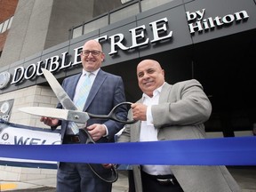 Windsor Mayor Drew Dilkens, left, and hotel owner Shmuel Farhi cut the ribbon during a grand opening for the new DoubleTree by Hilton Windsor Hotel and Suites on Tuesday, Nov. 29, 2022.