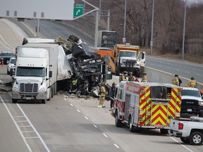 Emergency vehicles and crews are shown near two transport trucks that came into collision on March 23, 2021, on Highway 402 near Christina Street in Sarnia. Drivers of both trucks were taken to hospital and a section of the westbound highway was closed. Paul Morden/The Observer