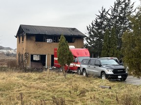 Police and fire crews remained at the scene of a house fire on White Oak Road on Sunday Nov. 27, 2022. The home and adjacent land were slated for redevelopment into a 87-unit condo complex. (Jennifer Bieman/The London Free Press)