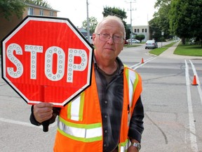 A Stratford crossing guard holds up a stop sign. (Postmedia Network file photo)