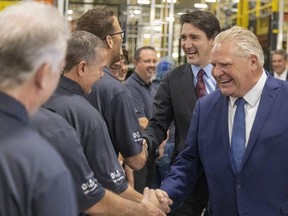 Prime Minister Justin Trudeau and Ontario Premier Doug Ford greet workers at the Cami Assembly auto plant in Ingersoll on Monday Dec. 5, 2022. Mike Hensen/The London Free Press