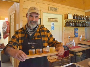 Brewer Nathan Nicholas serves a flight at Ursa Minor, a farm-based brewery for drinking and overnight stays on a remote ranch near Burns Lake, BC (Wayne Newton/Special to Postmedia Network)