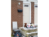 Neighbours and friends have placed teddy bears, flowers, children’s drawings and sweetgrass in a basket at the door of a townhouse unit on Boullee Street in northeast London where police are investigating two deaths. Photo taken on Sunday, Dec. 11, 2022. (Mike Hensen/The London Free Press)