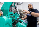Nader Basha of Basha Handy Candy in London explains the workings of a German-made taffy maker that he brought here from his late father's business in Jordan. Photograph taken on Sunday December 11, 2022. Mike Hensen/The London Free Press