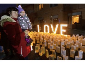 Tara MacIntosh holds one of her twins at the St. Joseph's Hospice Light the Night fundraiser in London. Gregor Leithead, her husband and the children's father, passed away there about a year ago. Photo taken on Wednesday Nov. 30, 2022. (Mike Hensen/The London Free Press)