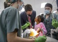 Four-year-old Amanda Ibeya throws a perturbed look at Prime Minister Justin Trudeau after he interrupted her while she was playing with dental student tools at Western University's Schulich school of medicine and dentistry in London on Thursday, Dec. 1, 2022. Trudeau was there to make an announcement about the new federal Canada Dental Benefit for children under 12. (Derek Ruttan/The London Free Press)