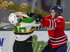 Calum Ritchie of the Oshawa Generals wallops Landon Sim of the London Knights during the second period of their game at Budweiser Gardens in London on Tuesday December 6, 2022. No penalty was called on the play. Oshawa won, 5-3. Derek Ruttan/The London Free Press/Postmedia Network