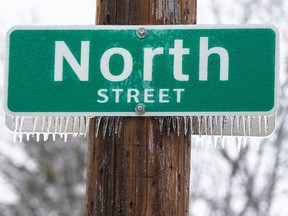 Ice clings to a North Street sign after a bout of freezing rain in London on Thursday, Dec. 15, 2022. Derek Ruttan/The London Free Press