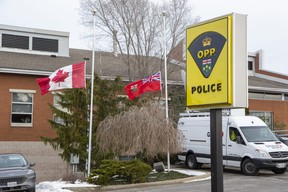 Flags are lowered to half-staff at the OPP detachment in Cayuga, Ont. on Wednesday, Dec. 28, 2022 after OPP Const. Grzegorz (Greg) Pierzchala, who worked out of the detachment, was shot and killed  just west of Hagersville Tuesday. Letter-writer James D. Lush is angry the male suspect was released on bail six months ago. (Derek Ruttan/The London Free Press)