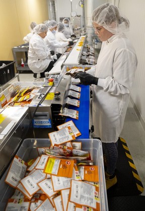 Miranda Boisvert of Indiva seals cannabis edibles in packages at the company plant in London. Photograph taken on Wednesday, Nov. 30, 2022. (Mike Hensen/The London Free Press)