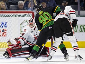 Landon Sim of the London Knights can't get his stick on a shot in front of Niagara IceDogs goalie Josh Rosenzweig while being checked by Rodwin Dionicio in the first period of their OHL game on Friday Dec. 2, 2022 at Budweiser Gardens in London. The Knights won, 2-1. Mike Hensen/The London Free Press
