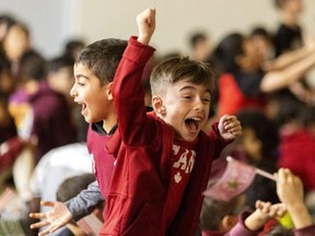 London Islamic School students Mustafa Alomari and Noah Halbouni, both 6, dance with joy while watching Morocco play France in the World Cup semifinal. Students were allowed to watch the game in the school gym. Photo taken on Wednesday Dec. 14, 2022. (Mike Hensen/The London Free Press)