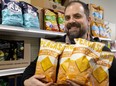 Michael Sutherland, manager of Quarter Master Foods in Wortley Village, holds its remaining stock of Peacasa chickpea chips. “Whatever we get in, we sell out," he said of the chips that are made in London. Photograph taken on Monday, Dec. 19, 2022. (Mike Hensen/The London Free Press)