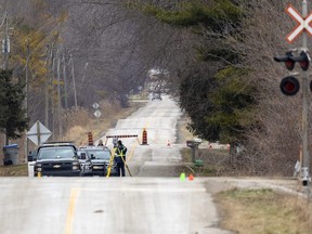 OPP officers were at Amiens Road near Komoka, west of London, on Thursday, Dec. 22, 2022 after a single-vehicle rollover killed two people and sent three others – two with life-threatening injuries – to hospital. (Mike Hensen/The London Free Press)