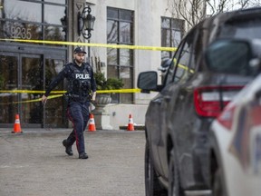 A York regional police officer walks outside a condo in Vaughan on Monday, Dec. 19, 2022, as police investigate a shooting the day before that left six people dead, including the shooter. (Ernest Doroszuk/Postmedia Network)