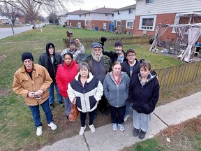 Several residents of apartments in four-plexes owned by Vanroboys Enteprises Ltd. are worried they could be evicted after receiving notices stating they must remove fences, shed, gazebos and even a swing set from around their units with seven days. Many of the residents seen here are on Ontario Disability Support Program pensions and fear the financial impact if they have to try to find a new apartment with the much higher rental rates in today's market. (Ellwood Shreve/Postmedia Network)