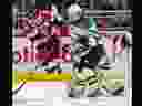 London Knights goalie Brett Brochu makes a toe save despite being screened by his defenceman Sam Dickinson and Ottawa 67's forward Vinzenz Rohrer during their game at Budweiser Gardens in London on Friday December 9, 2022. Derek Ruttan/The London Free Press