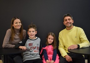 Iryna Bilovol, left, sits with her son Oleksandr, 8, daughter Polina, 5, and husband Mykola at their new dessert shop in Strathroy on Thursday, Jan.  12, 2023. The family arrived in Canada six months ago after fleeing war-torn Ukraine.  (Calvi Leon/The London Free Press)