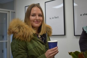 Jane Bilyayeva enjoys a latte at U.Cake, a Ukrainian dessert shop in Strathroy, on Thursday, Jan. 12, 2023. She was one of the last opening-day customers to get some macarons before they sold out. (Calvi Leon/The London Free Press)