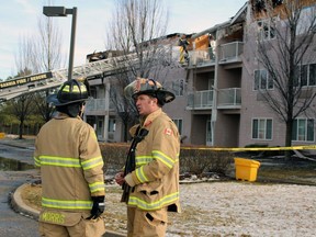 From right, Curtis Lamberts, a captain with the Sarnia fire department, and acting captain Eric Morris discuss the blaze at Fairwinds Lodge retirement home. Photo taken on Monday, Jan. 16, 2023. (Terry Bridge/Postmedia Network)