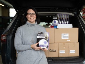 Sonja Sonnenberg, manager of St. Leonard's Community Services' Project Home, shows off donated smoke and carbon monoxide alarms that will go to marginalized Londoners aided by the city-funded housing-first initiative. (Jonathan Juha/The London Free Press)