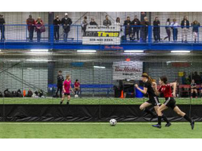 St. Thomas Reds 15G player Maya Ambrose chases down London Alliance opponent Claire Edwards during a game at London’s indoor soccer hub, the BMO Centre, on Sunday Jan. 22, 2023. (Mike Hensen/The London Free Press)