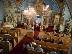 Worshippers, many of whom are Ukrainians that fled their home country during Russia's invasion, attend the Christmas service at the Ukrainian Orthodox Church of the Holy Trinity in London on Jan. 7, 2023. (Calvi Leon/The London Free Press)