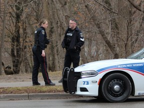Police officers are shown at the Wortley Road entrance to Thames Park, where emergency crews found a body on the morning of Wednesday, Jan. 18, 2022. (DALE CARRUTHERS/The London Free Press)
