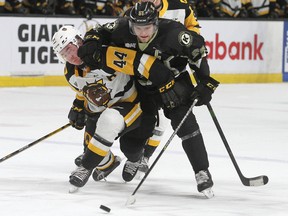 Kingston Frontenacs star Shane Wright tries to get past Hamilton Bulldogs defenceman Nathan Staios during Ontario Hockey League action at the Leon's Centre in Kingston on Friday March 18, 2022. Ian MacAlpine/Kingston Whig-Standard