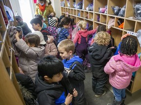 Kindergarten students remove their outdoor clothes upon entering Sir Arthur Currie Public School in London on Thursday March 10, 2022. Derek Ruttan/The London Free Press