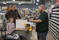 Nine-year-old Bella Holmes and her father Andrew purchase comic books from Tyler Anderson at L.A. Mood Comics and Games at 100 Kellogg Lane in London on Friday. The possibility of a recession hangs over the country, as London's jobless rate rises slightly, according to just-released December figures. (Derek Ruttan/The London Free Press)