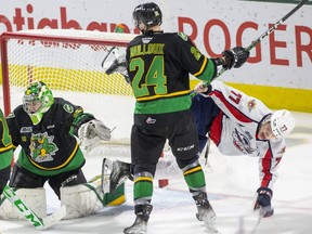London Knights defenceman Logan Mailloux helps out his goalie Brett Brochu by upending James Jodoin of the Windsor Spitfires in a game at Budweiser Gardens in London on Sunday, Jan. 15, 2023. (Derek Ruttan/The London Free Press)