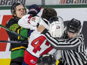 Max McCue of the London Knights (left) and Jacob Holmes of the Windsor Spitfires received roughing penalties for a post-whistle skirmish during their game at Budweiser Gardens in London on Jan. 15, 2023. (Derek Ruttan/The London Free Press)