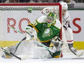 London Knights goalie Brett Brochu makes a save during a game against Gavin Bryant and the Owen Sound Attack at Budweiser Gardens in London, Ont. on Saturday January 21, 2023. (Derek Ruttan/The London Free Press)