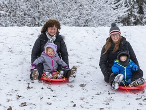 L to R: Deborah Carver (grandma) sleds with Hannah Huffman (2) while mom Jess Huffman sleds with Wesley Huffman (1) at Springbank Park in London on Monday January 23, 2023. Derek Ruttan/The London Free Press/Postmedia Network