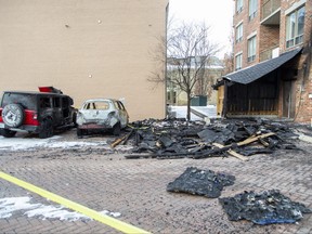 Two vehicles and a garbage shelter were damaged in a fire at 22 Picton St. in downtown London on Tuesday, Jan. 24, 2023. Derek Ruttan/The London Free Press