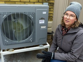 Skylar Franke, former executive director of the London Environmental Network, shows a heat pump installed with a rebate that allows the use of the electrical grid for heating rather than natural gas that causes greenhouse gas emissions. Photograph taken in London on Dec. 23, 2021.  Mike Hensen/The London Free Press
