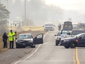 OPP traffic investigators gather evidence on Monday, Jan. 3, 2023, at the scene of a collision that killed a cyclist on Wellington Road south of Ferguson Line in Elgin County. Mike Hensen/The London Free Press