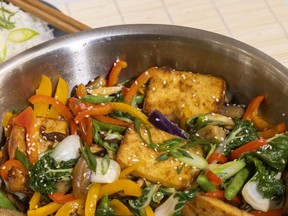 Vegetable stir-fry with baked tofu, served with your favourite spicy Asian condiment, is a great way to mark Chinese New Year this weekend, Jill Wilcox says. (Mike Hensen/The London Free Press)