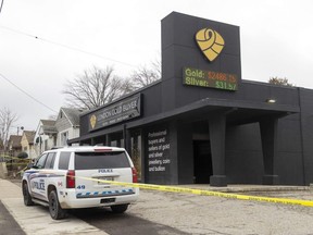 Police vehicles sit outside London Gold Buyer at 475 Highbury Ave. N., in London on Thursday, Jan. 5, 2023, following an armed robbery in which the owner and a female employee were injured. (Mike Hensen/The London Free Press)