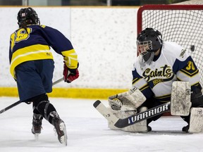 Dani Kidder of the St. Joseph's Rams scores on Zhawanoogbiik Riley of the Strathroy District collegiate institute Saints in a TVRA Central girls hockey game at Gemini Arena in Strathroy on Thursday, Jan. 12, 2023. (Mike Hensen/The London Free Press)