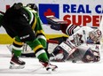 Ryan Humphrey of the London Knights tries to get his stick on a loose puck in front of Guelph Storm goalie Patrick Leaver who manages to cover it up at Budweiser Gardens in London on Jan. 13, 2023. (Mike Hensen/The London Free Press)